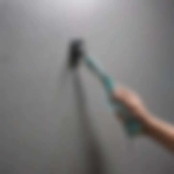 Demonstration of a gentle cleaning technique on a painted wall