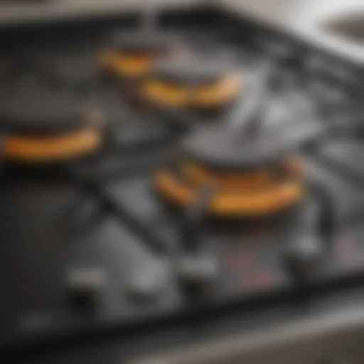 A close-up view of a contemporary gas stovetop showcasing its burners and knobs.