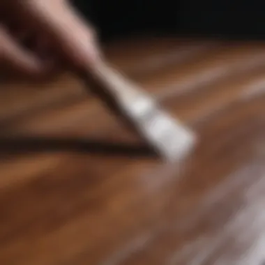 Close-up of applying paint to wood grain