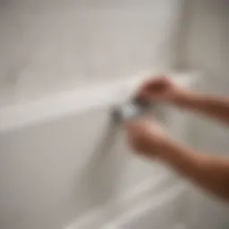 Close-up view of a bathtub with old caulk being removed