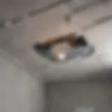 Close-up view of a cracked bathroom ceiling highlighting structural damage