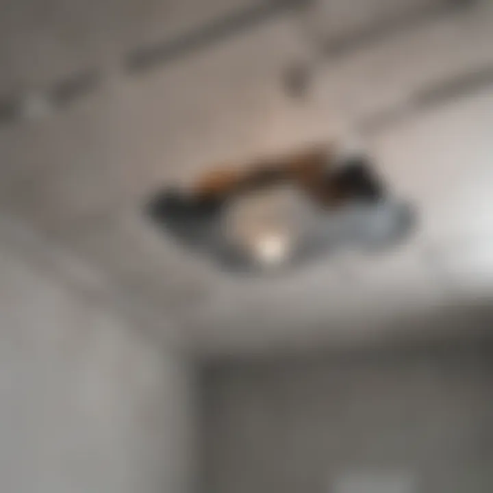 Close-up view of a cracked bathroom ceiling highlighting structural damage
